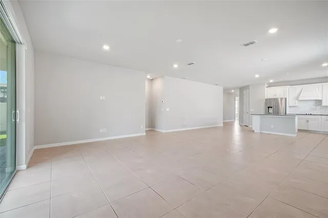 a view of a kitchen with a sink and a refrigerator