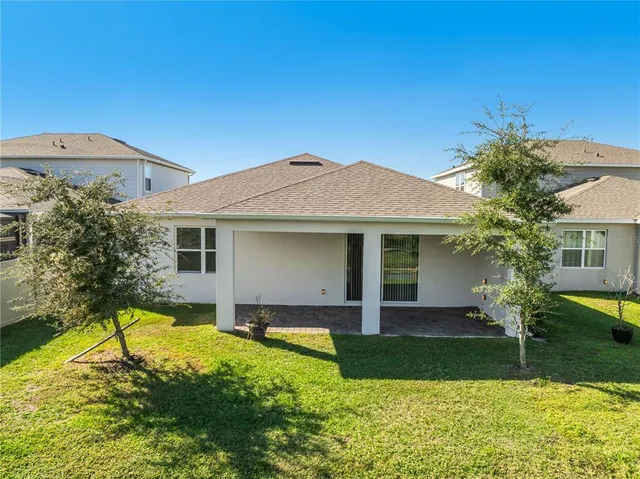 a view of a house with swimming pool and a yard