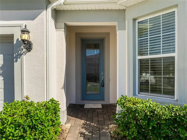 a view of a door and a window of the house