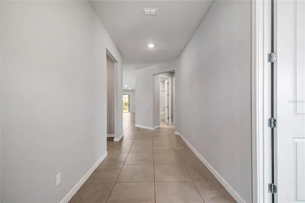 a view of hallway with a window and a glass door