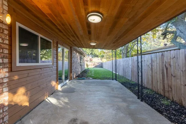 a view of a backyard with wooden fence