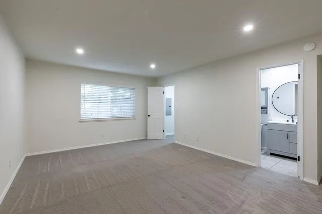 an empty room with a space and windows