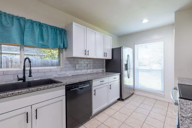 a kitchen with a sink cabinets and window