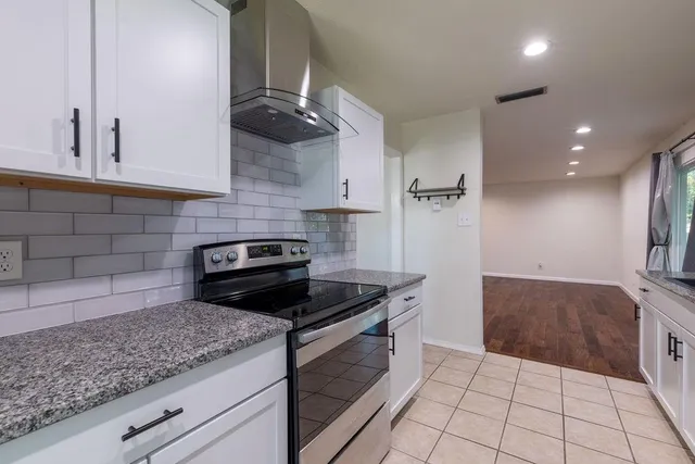 a kitchen with granite countertop a sink and cabinets