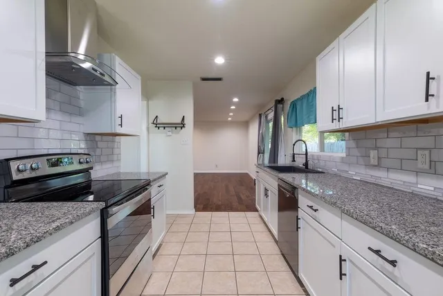 a kitchen with a sink stove and cabinets