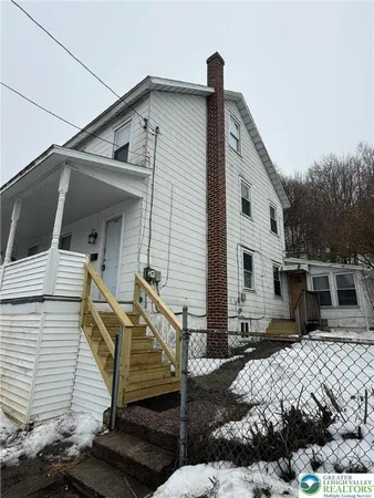 a front view of a house with stairs