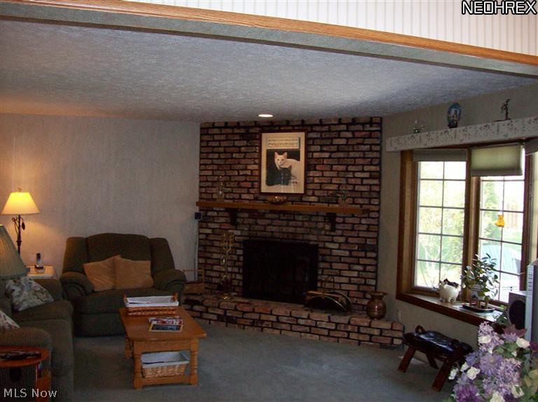 7555 Stone Road Medina, OH 44256 - Photo 6 of 25 Cozy great room with beautiful brick W/B fireplace with raised hearth. Bay/Bow window with backyard views.