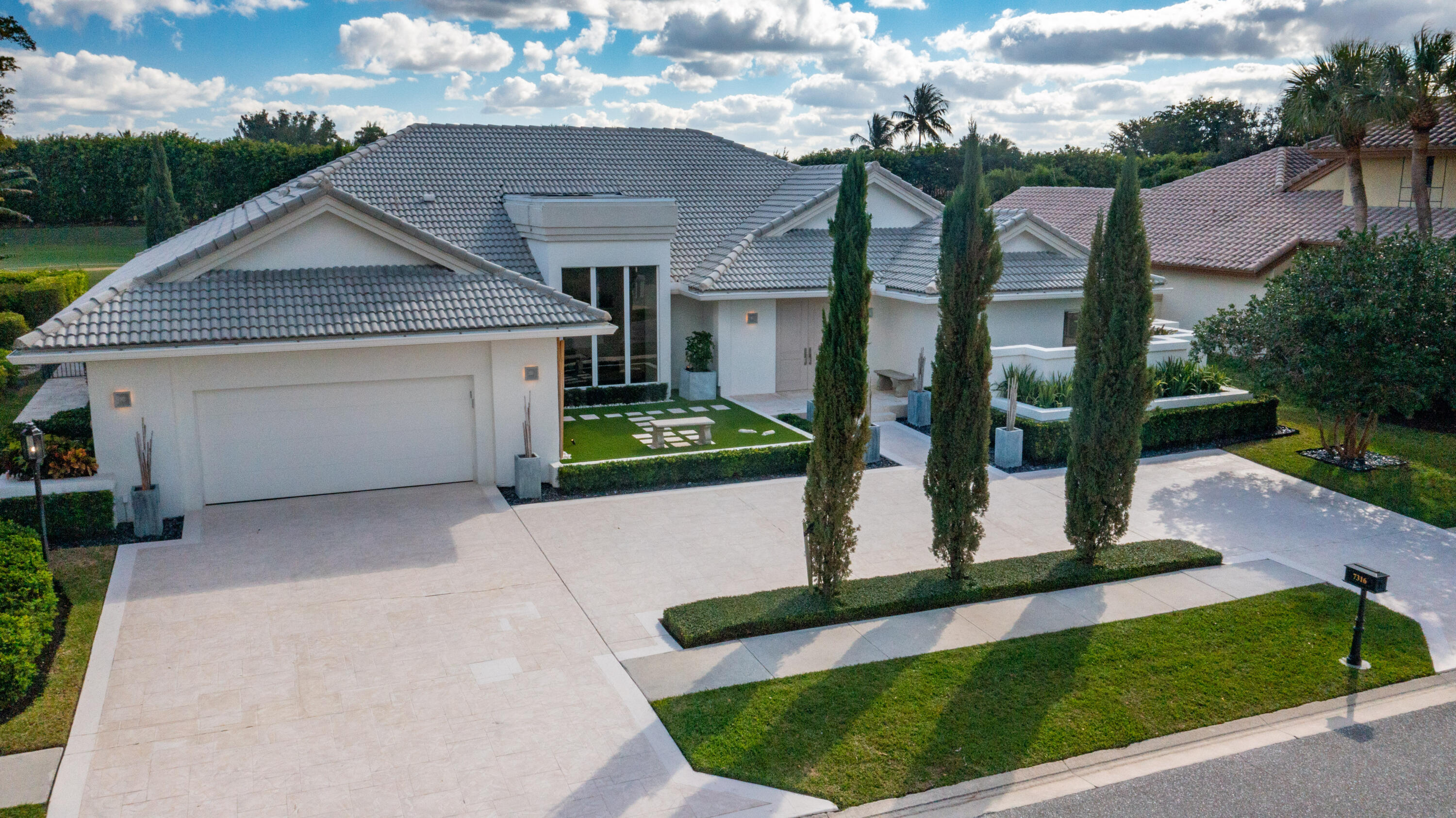 7316 Mandarin Drive Boca Raton, FL 33433 - Photo 1 of 45 a front view of a house with garden