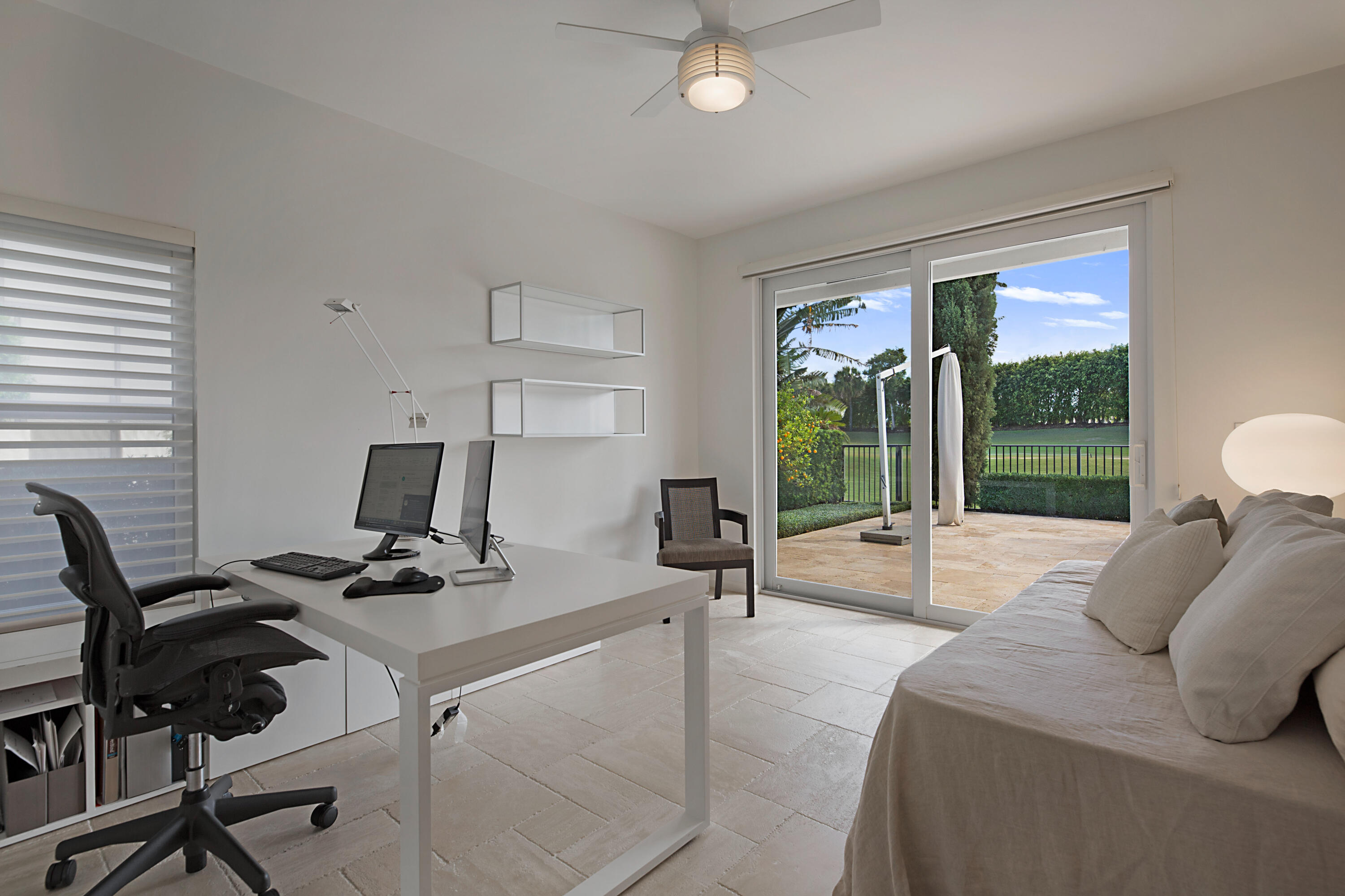 7316 Mandarin Drive Boca Raton, FL 33433 - Photo 28 of 45 a bedroom with a bed and large windows