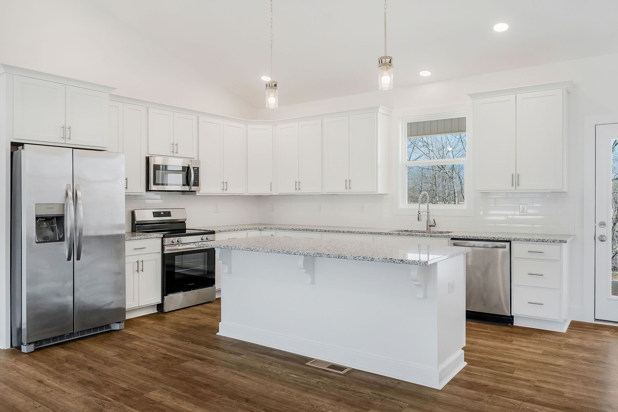 172 Johnson Chapel Road Sparta, TN 38583 - Photo 11 of 38 a kitchen with stainless steel appliances white cabinets a sink a stove a refrigerator and microwave