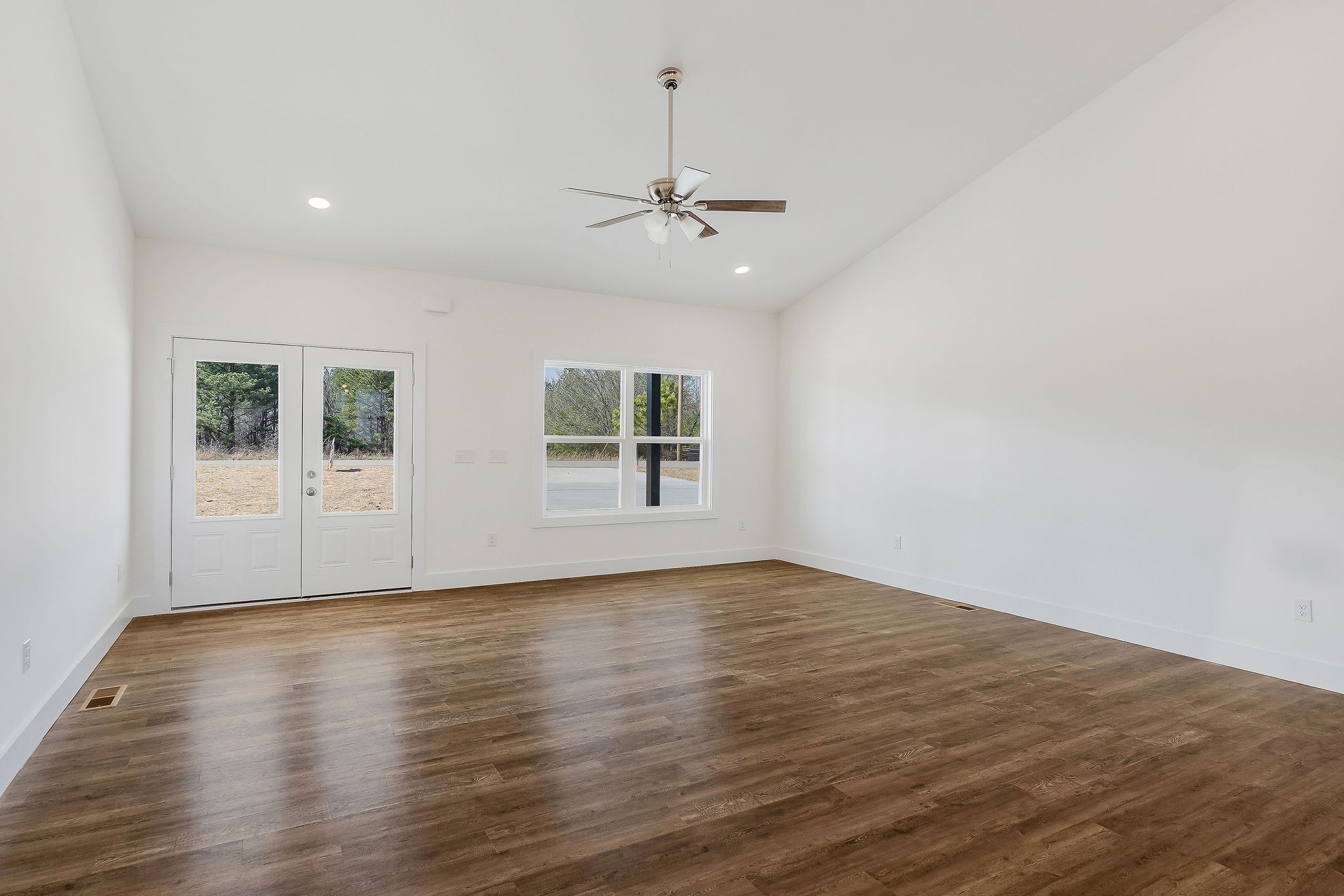 172 Johnson Chapel Road Sparta, TN 38583 - Photo 10 of 38 an empty room with wooden floor ceiling fan and windows