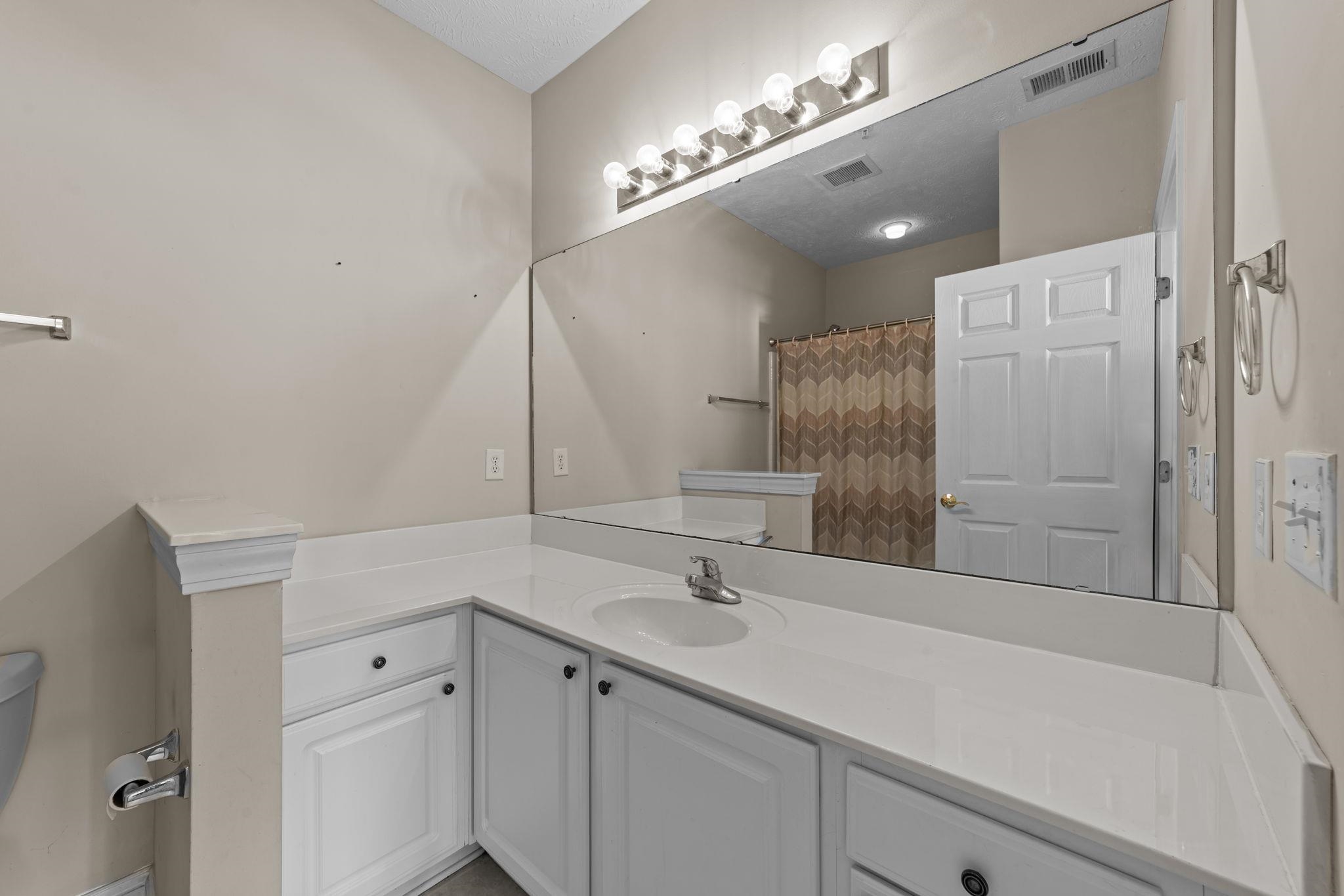 120 Fountain Pointe Lane, Unit 103 Myrtle Beach, SC 29579 - Photo 18 of 26 Bathroom featuring vanity and curtained shower