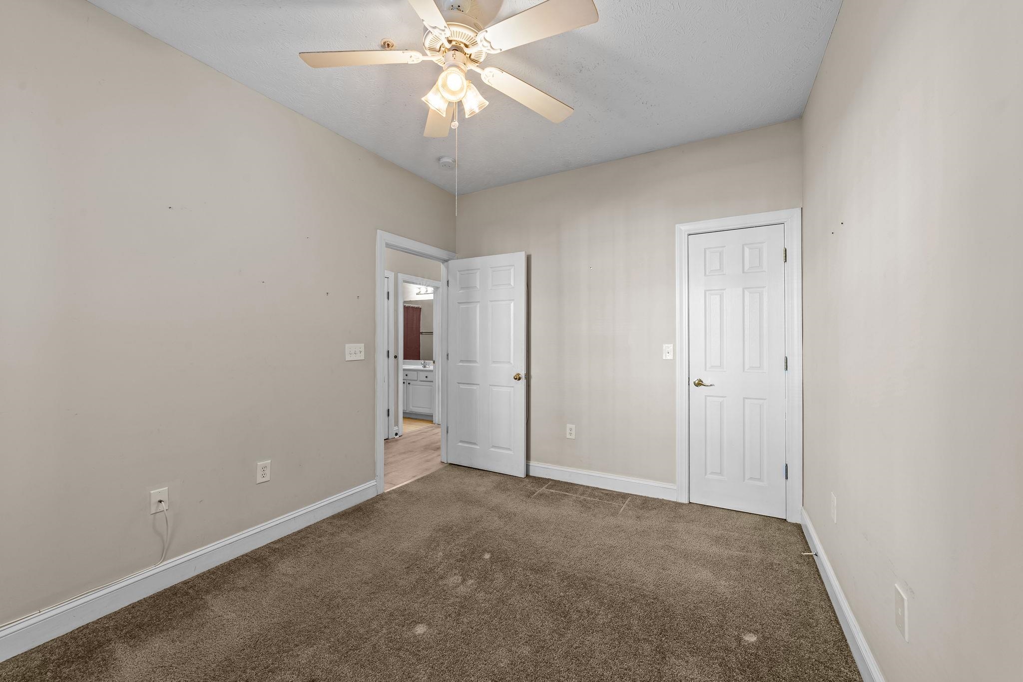 120 Fountain Pointe Lane, Unit 103 Myrtle Beach, SC 29579 - Photo 7 of 26 Unfurnished bedroom with carpet floors and a ceiling fan