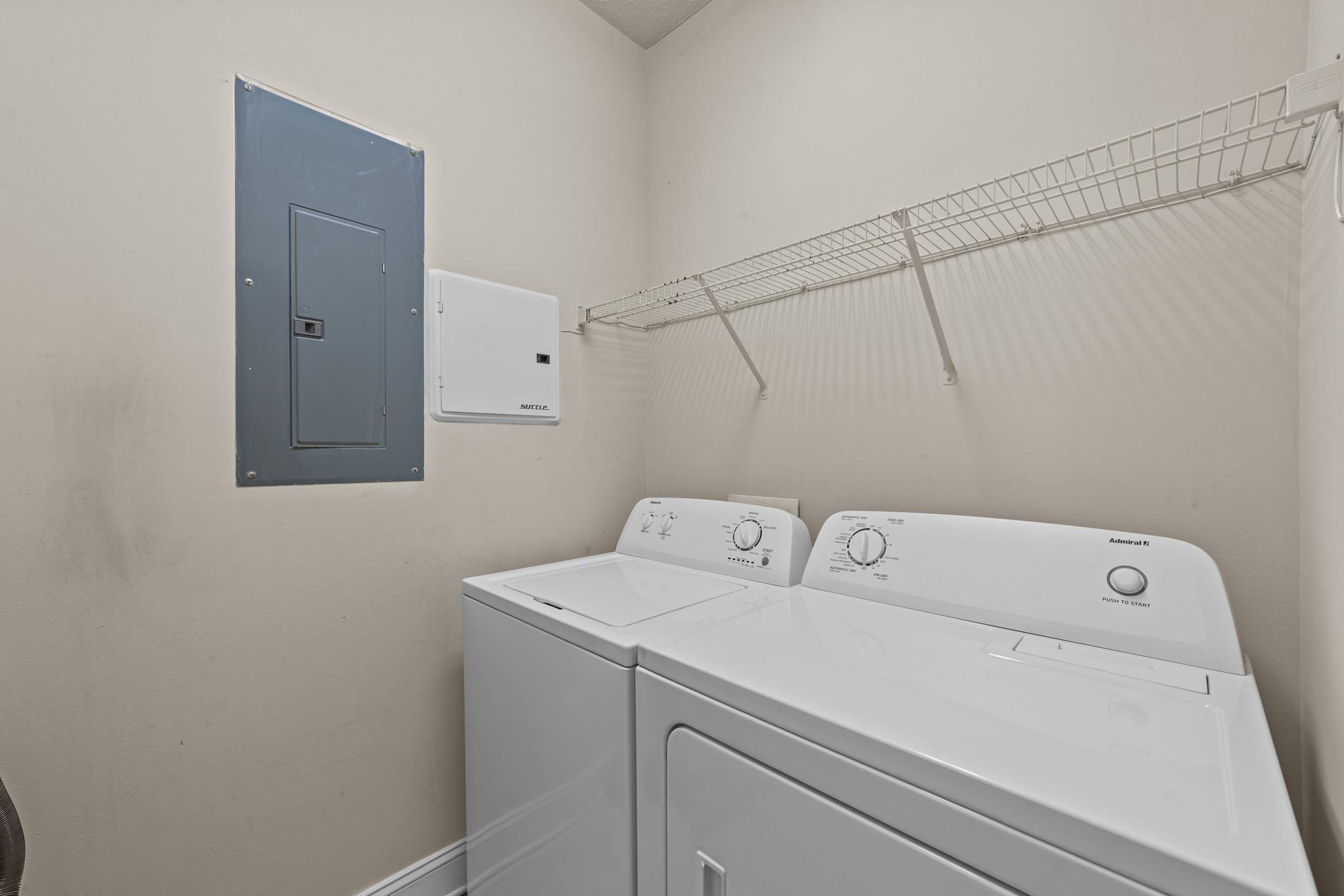 120 Fountain Pointe Lane, Unit 103 Myrtle Beach, SC 29579 - Photo 9 of 26 Laundry room with electric panel and washing machine and clothes dryer