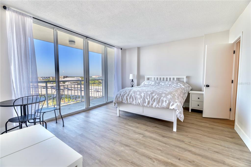 100 Pierce Street, Unit 1102 Clearwater, FL 33756 - Photo 20 of 45 a bedroom with a bed and wooden floor