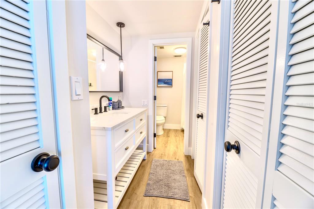 100 Pierce Street, Unit 1102 Clearwater, FL 33756 - Photo 22 of 45 a bathroom with a double vanity sink a mirror and shower