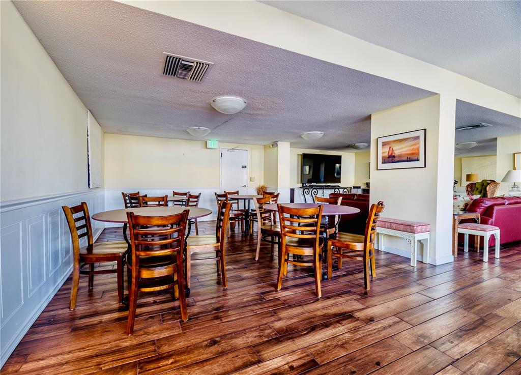 100 Pierce Street, Unit 1102 Clearwater, FL 33756 - Photo 31 of 45 a view of a dining room with furniture and wooden floor