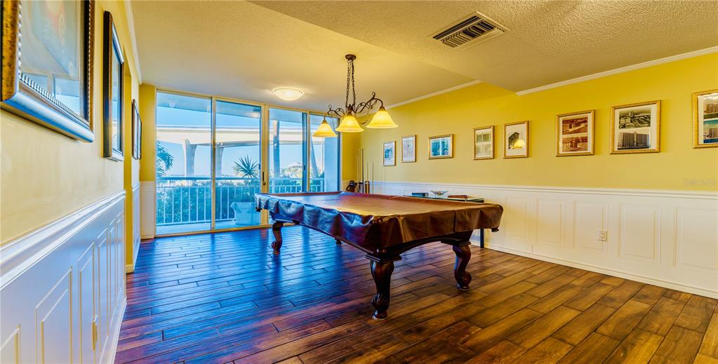 100 Pierce Street, Unit 1102 Clearwater, FL 33756 - Photo 35 of 45 a living room with table chairs and a dining table with wooden floor