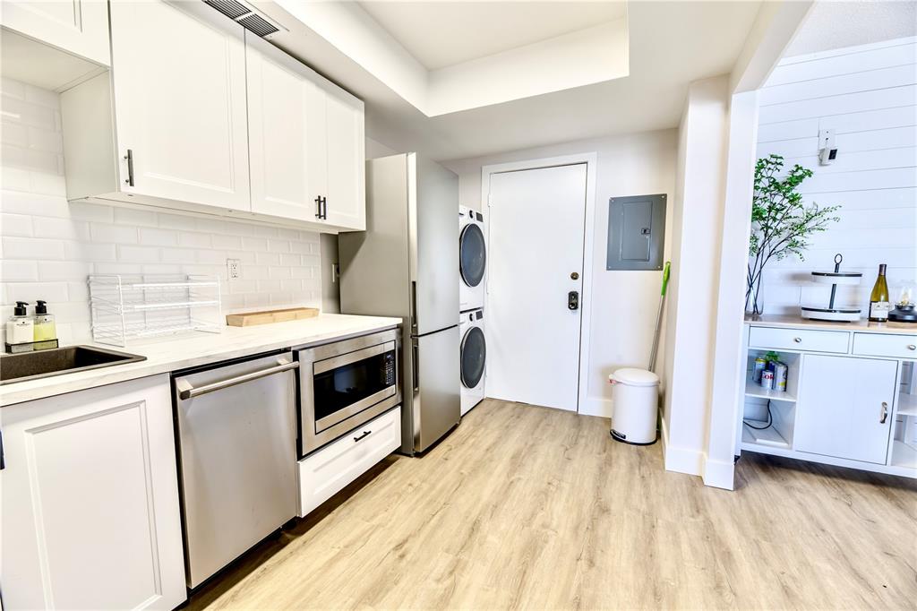 100 Pierce Street, Unit 1102 Clearwater, FL 33756 - Photo 10 of 45 a kitchen with a stove a sink and a refrigerator