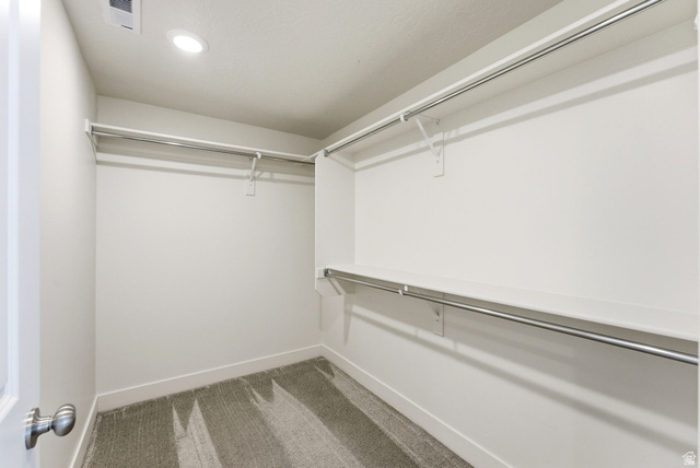108 West Monte Rosa Lane Midway, UT 84049 - Photo 33 of 48 Walk-in closet featuring built-in shelving, chrome hanging rods, recessed ceiling lighting, and soft carpet flooring