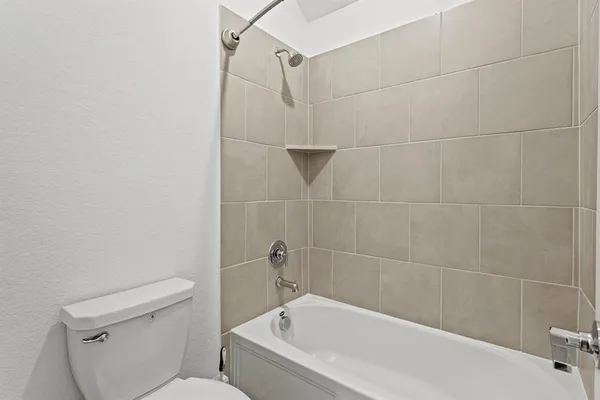 a white bath tub sitting next to a toilet