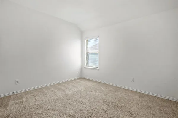 an empty room with windows and cabinet