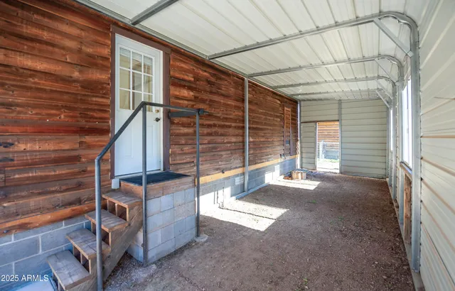a view of backyard with a large tree and wooden roof
