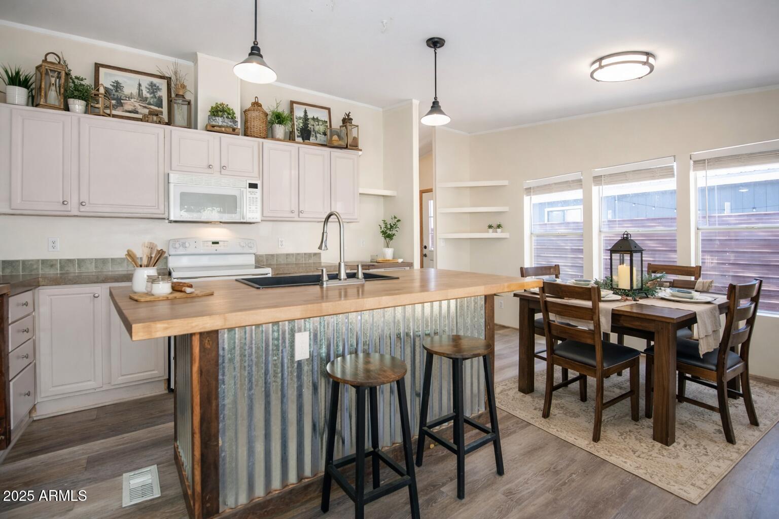 221 Standage Drive Payson, AZ 85541 - Photo 6 of 27 a kitchen with stainless steel appliances granite countertop table chairs sink and cabinets