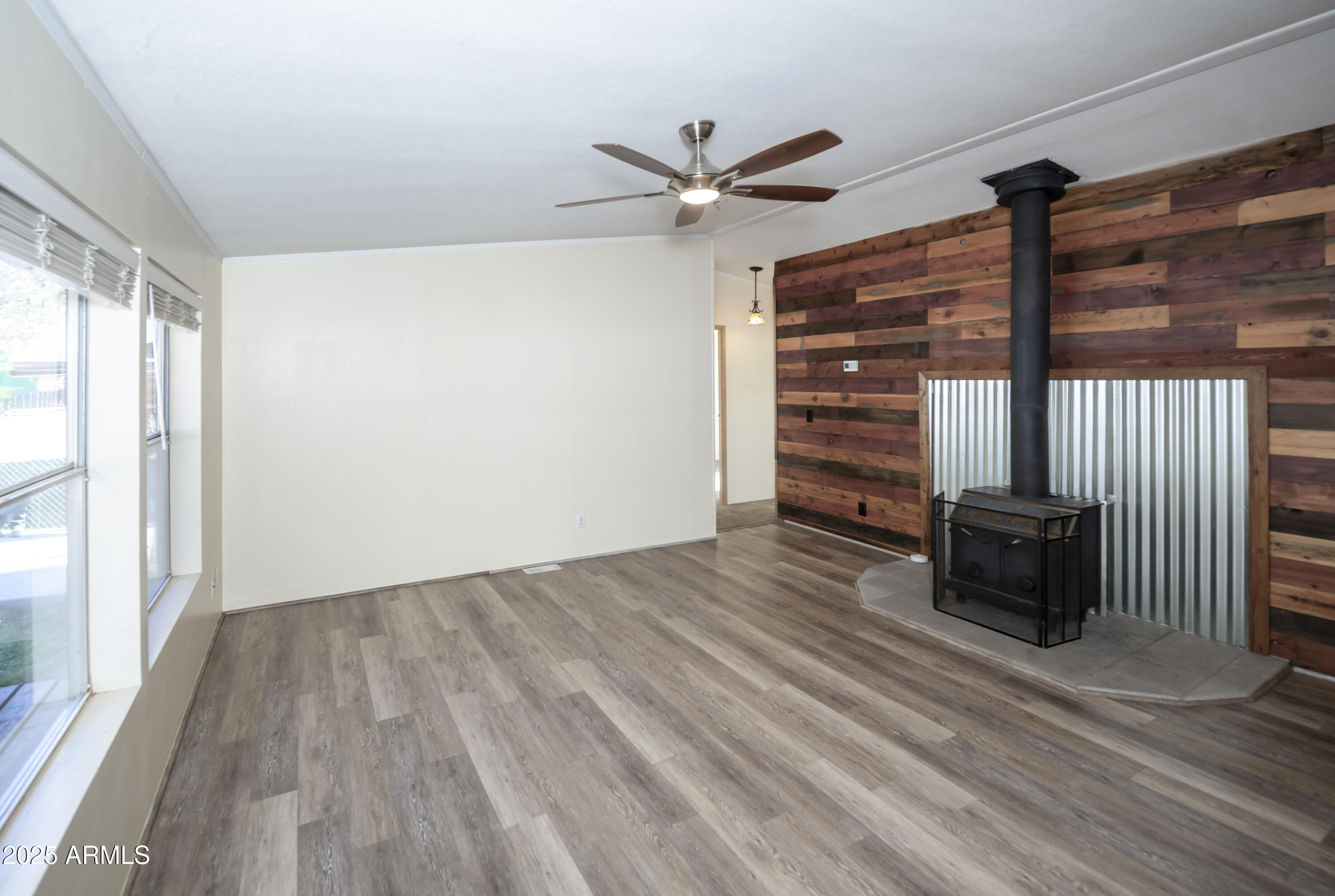 221 Standage Drive Payson, AZ 85541 - Photo 10 of 27 a view of an empty room with a window and wooden floor
