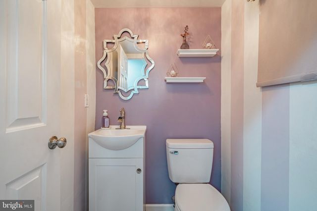 a bathroom with a toilet a sink and mirror