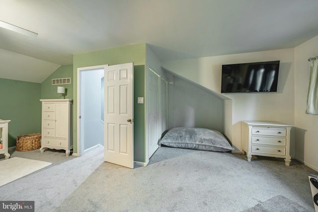 a bedroom with a bed and cabinets