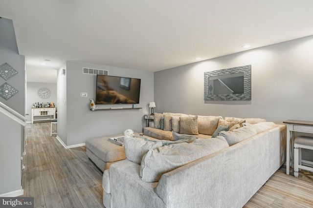 a living room with couches and a flat screen tv