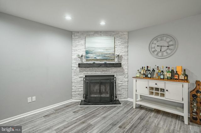 a view of a kitchen with a fireplace and wooden floor