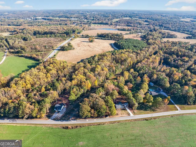 an aerial view of residential houses with outdoor space and river