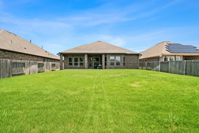 a view of a house with a yard and sitting area