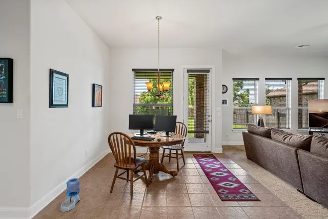 a dining room with furniture a rug and a chandelier