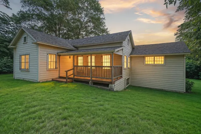 a view of a backyard with a garden and barbeque