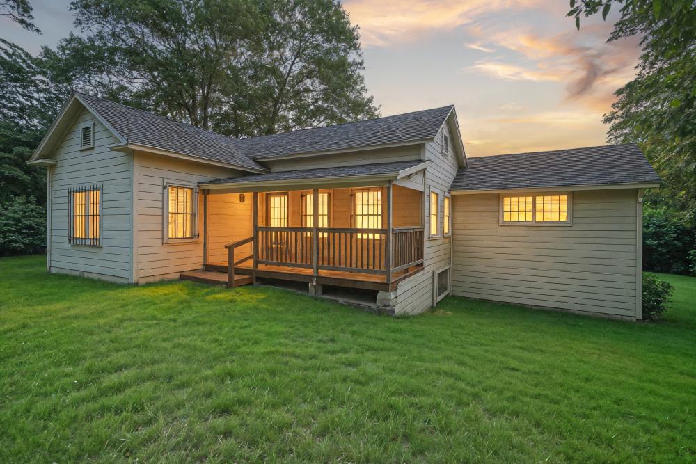 a view of a backyard with a garden and barbeque