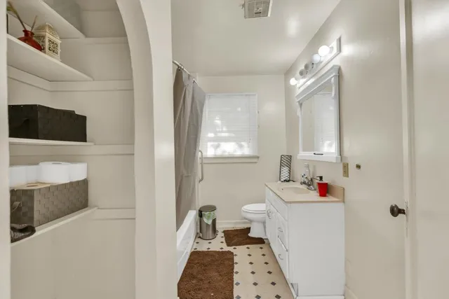 a kitchen with stainless steel appliances granite countertop a refrigerator a stove and a sink