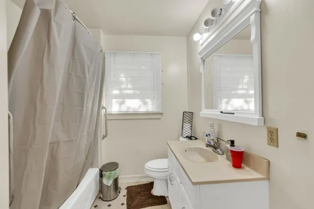 a kitchen with cabinets appliances a sink and a window