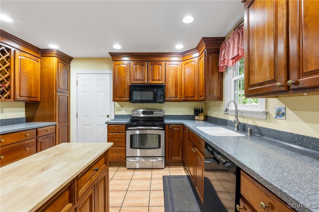 4018 Timber Ridge Road Midlothian, VA 23112 - Photo 11 of 43 a kitchen with stainless steel appliances granite countertop sink stove refrigerator and cabinets