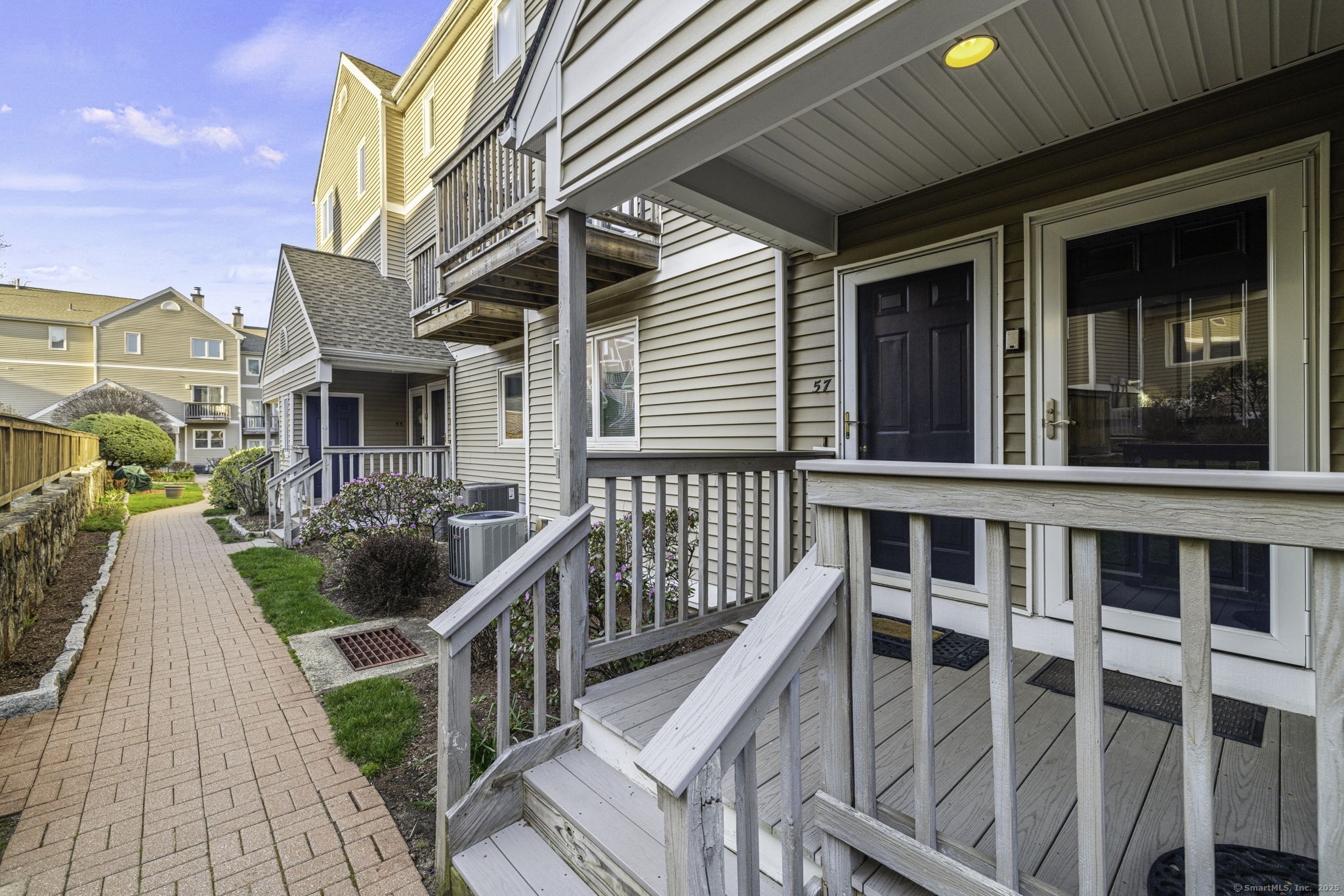 a front view of a house with outdoor seating and city view