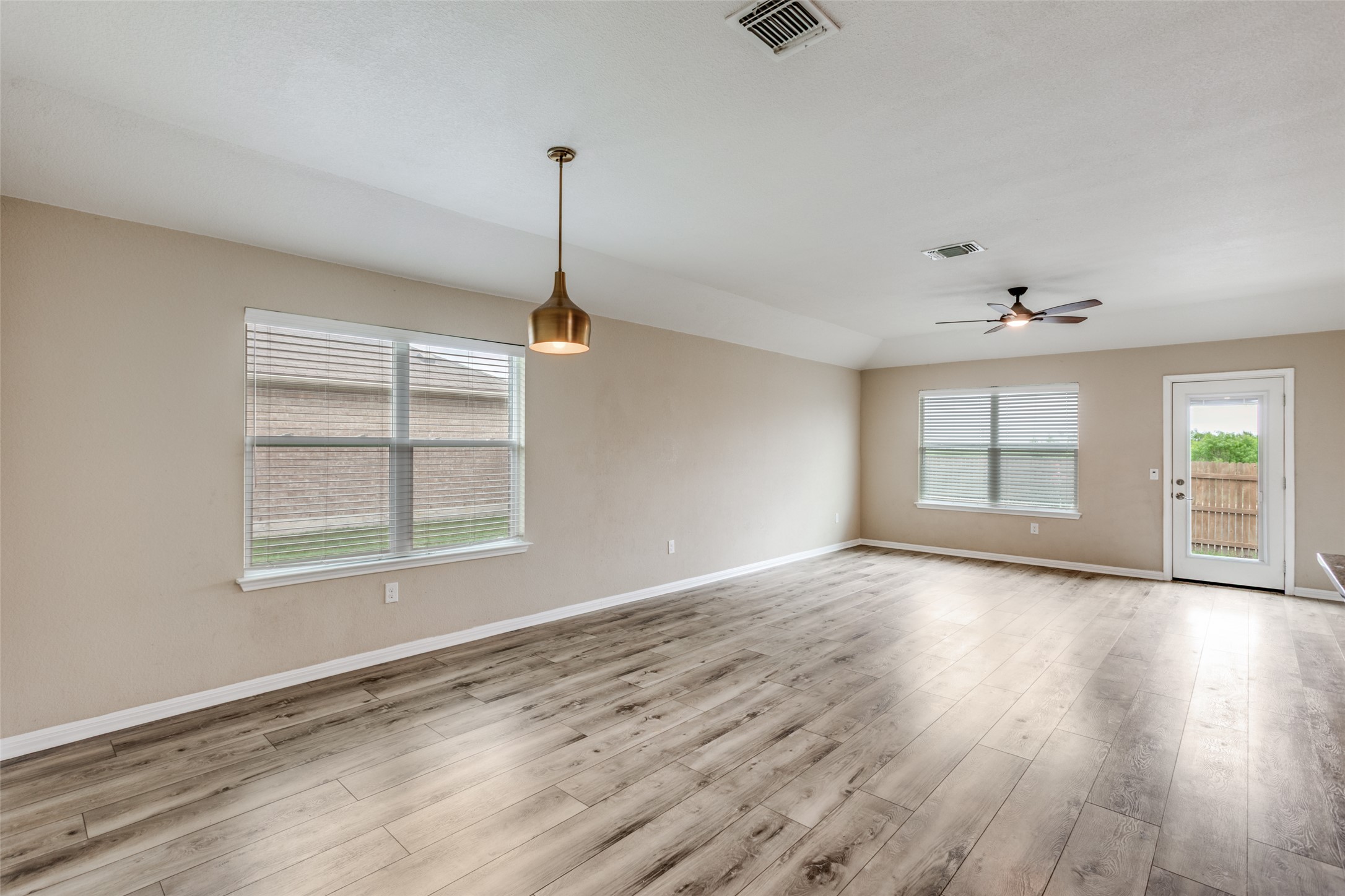 2909 Centrum Drive Austin, TX 78754 - Photo 7 of 30 Spacious open-concept living area featuring light wood-look flooring, neutral wall tones, and recessed lighting