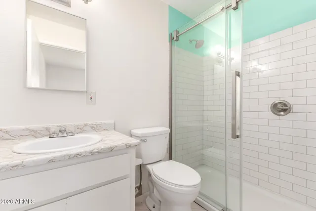 a bathroom with a sink toilet and shower