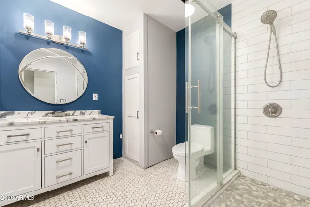 a bathroom with a toilet a sink and mirror