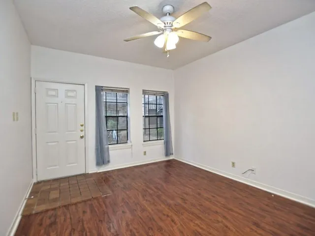 wooden floor in an empty room with a window