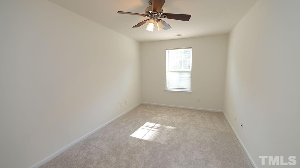 11710 Coppergate Drive, Unit 109 Raleigh, NC 27614 - Photo 11 of 15 an empty room with windows and fan