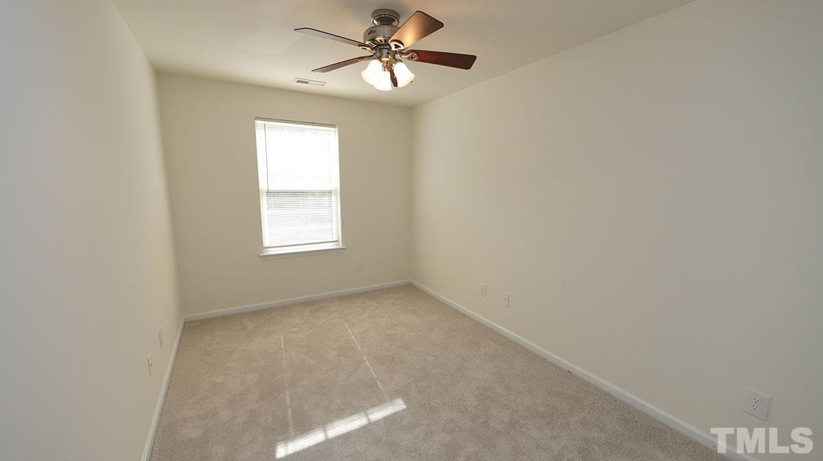 11710 Coppergate Drive, Unit 109 Raleigh, NC 27614 - Photo 12 of 15 an empty room with windows and fan