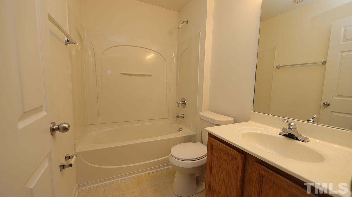 11710 Coppergate Drive, Unit 109 Raleigh, NC 27614 - Photo 13 of 15 a bathroom with a sink a toilet and shower