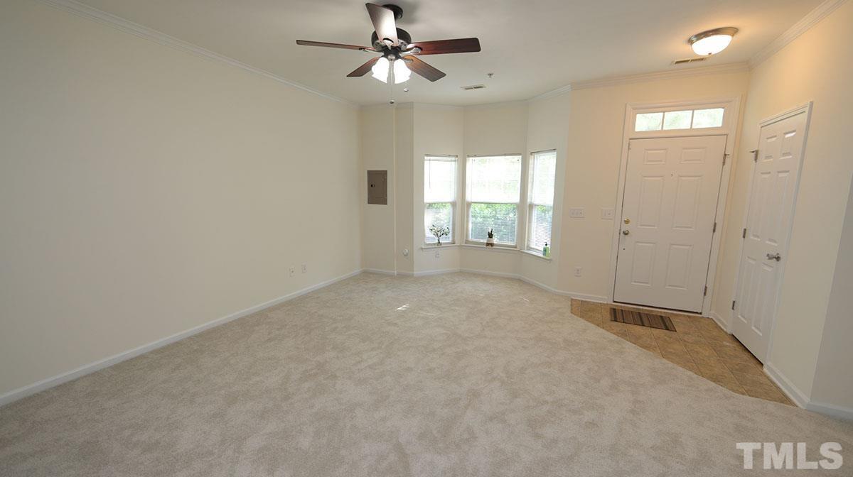 11710 Coppergate Drive, Unit 109 Raleigh, NC 27614 - Photo 3 of 15 an empty room with windows and fan chandelier